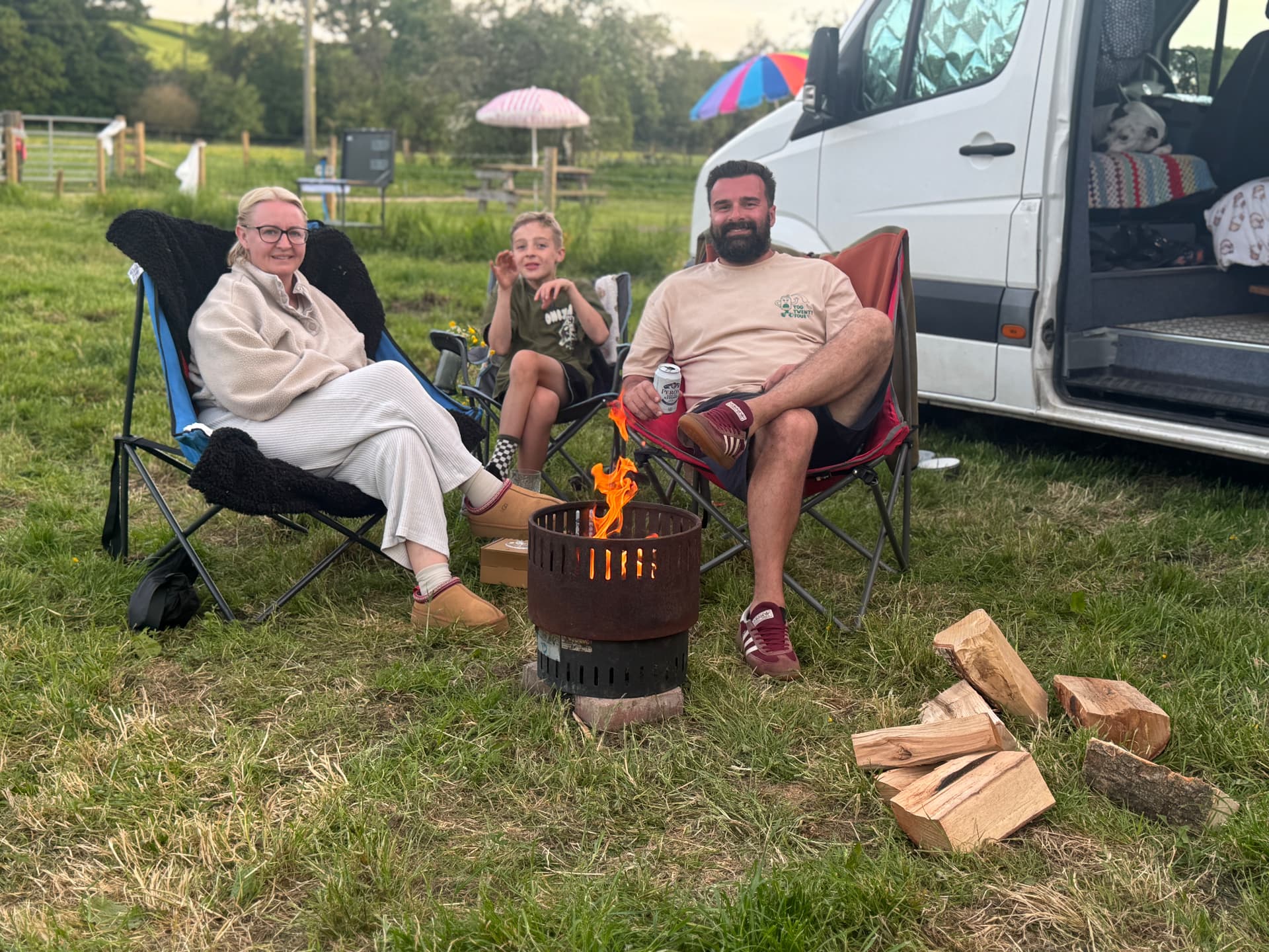 A family around a firepit at dusk